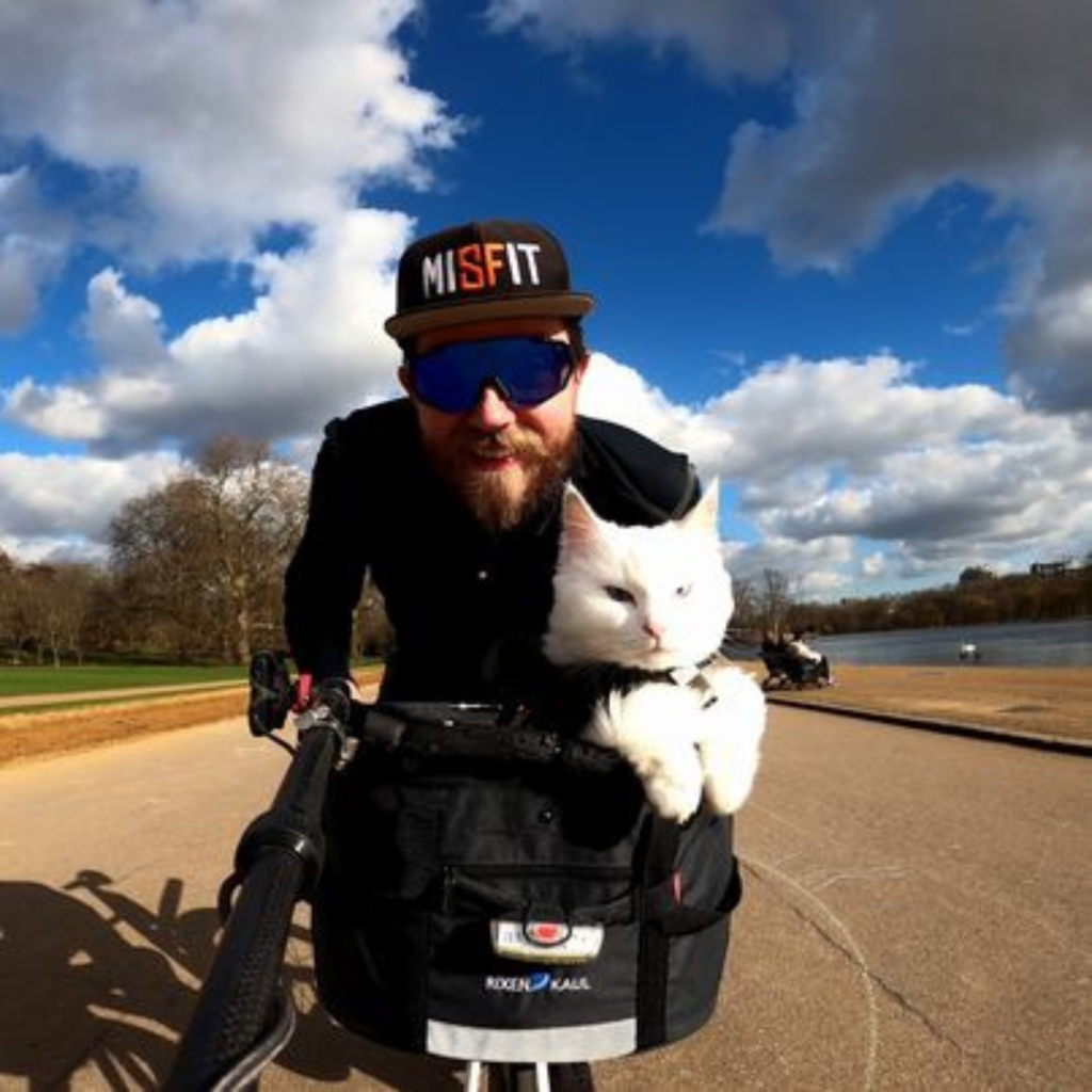 man on bicycle with cat